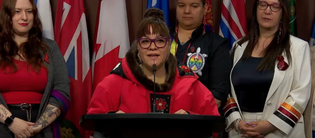Photo of Indigenous woman leader announcing new project at press conference.